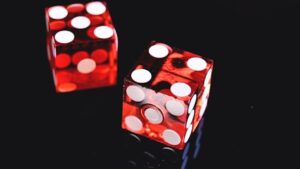 two red dice on a black background