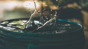 a close up freeze-frame image of the spash created as a drop of water enters a pool