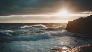 an image of waves crashing onto a beach with a sunset in the background